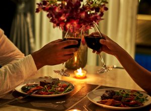 Happy couple on summer evening having romantic dinner.